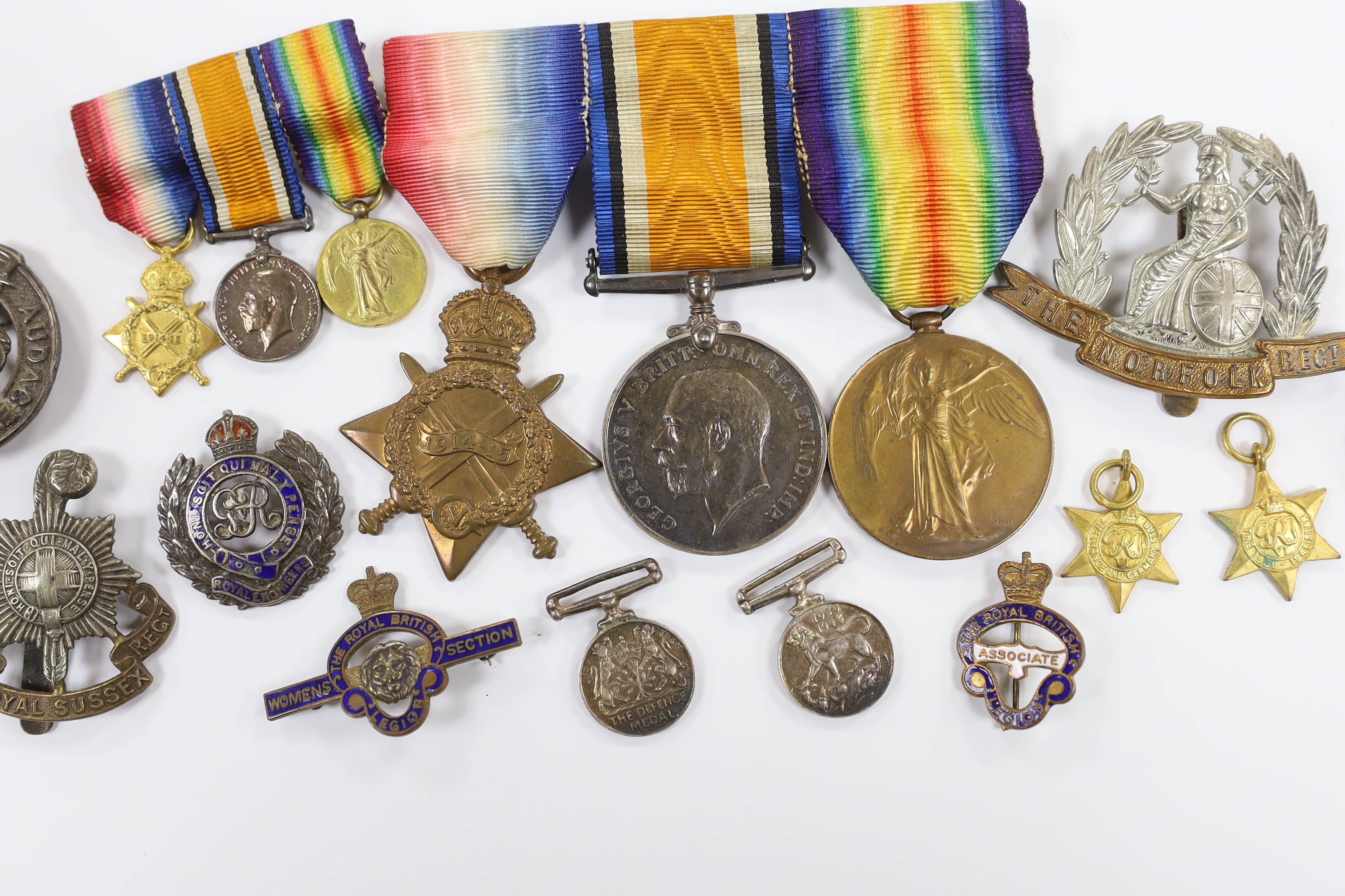 A WWI trio to Pte. W.K. Scudamore R.A.M.C. and miniatures, four WWII miniatures, five lapel badges, a silver Royal Engineers badge a Royal Sussex Reg. cap badge and a Norfolk Reg. cap badge
